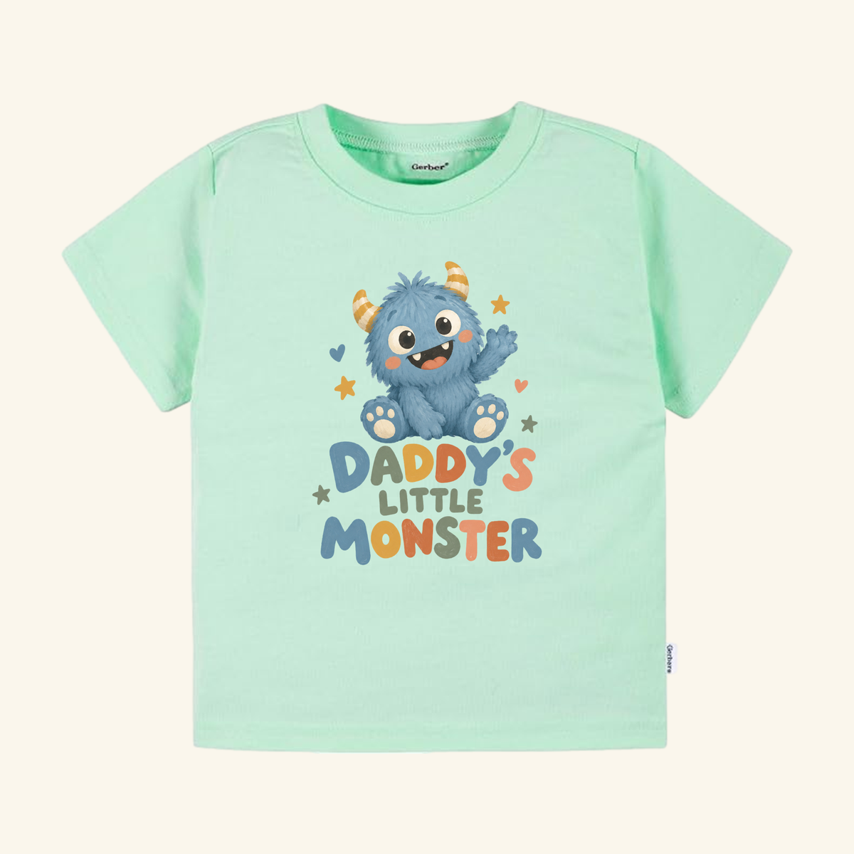 Mint green Daddy’s Little Monster Toddler Shirt – Cute Dad Monster Tee featuring a blue furry monster graphic and the text Daddy’s Little Monster.