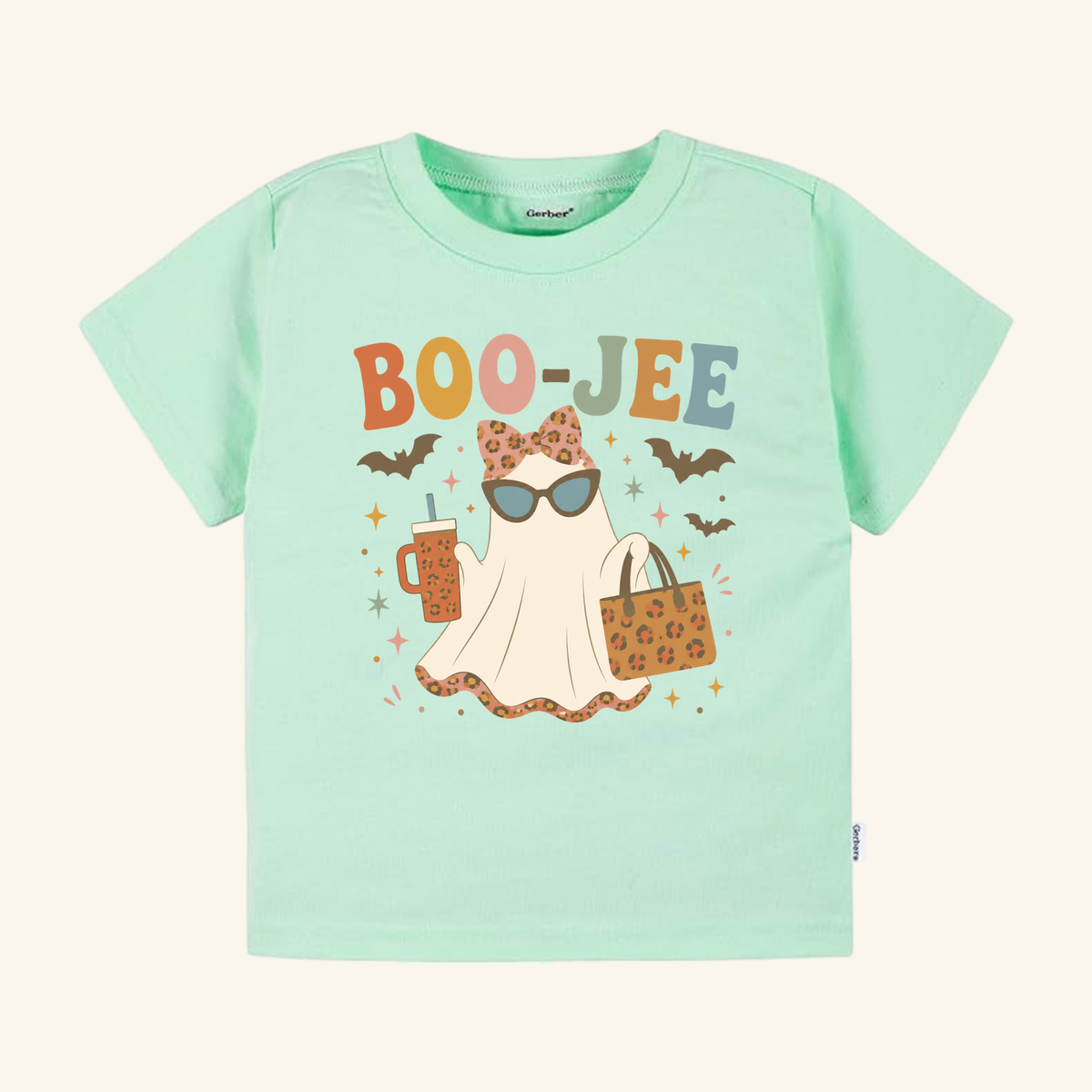 Light green Toddler Girl Halloween Shirt – Boo-Jee Ghost Short-Sleeve Tee featuring a specter wearing sunglasses and a leopard-print bow, holding a cup and a purse.