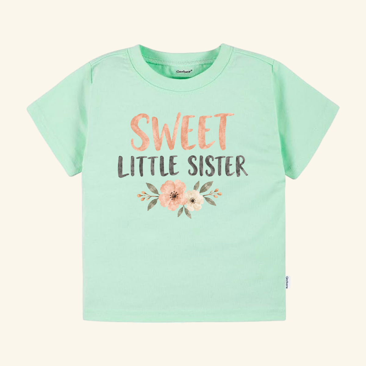 Sweet Little Sister Toddler Shirt – Floral Sibling Tee in mint green featuring SWEET LITTLE SISTER in peach and dark grey text above a small floral graphic.