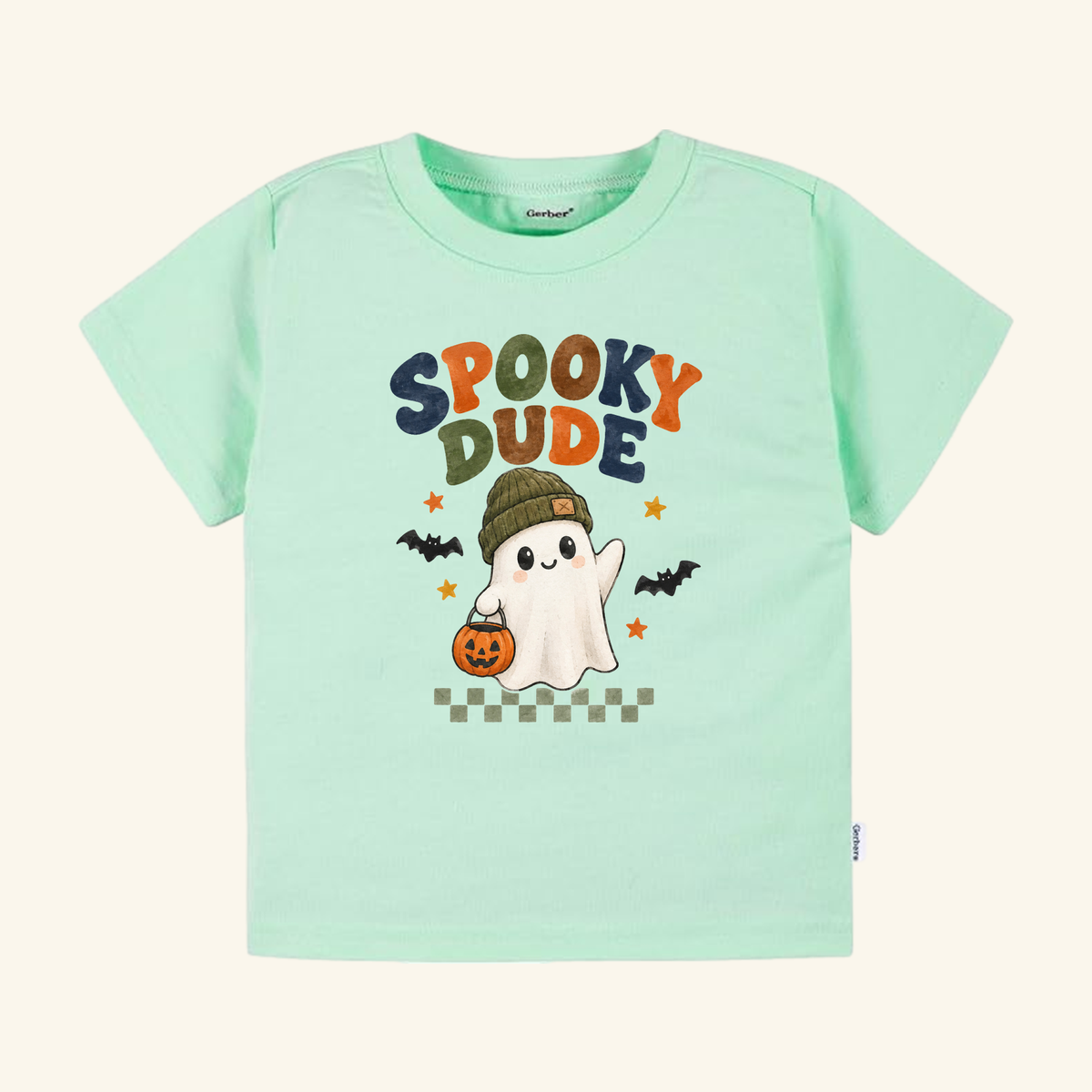 Light green short-sleeve Spooky Dude Ghost Toddler Halloween Shirt featuring a graphic of a ghost in a beanie holding a jack-o-lantern with the text SPOOKY DUDE.