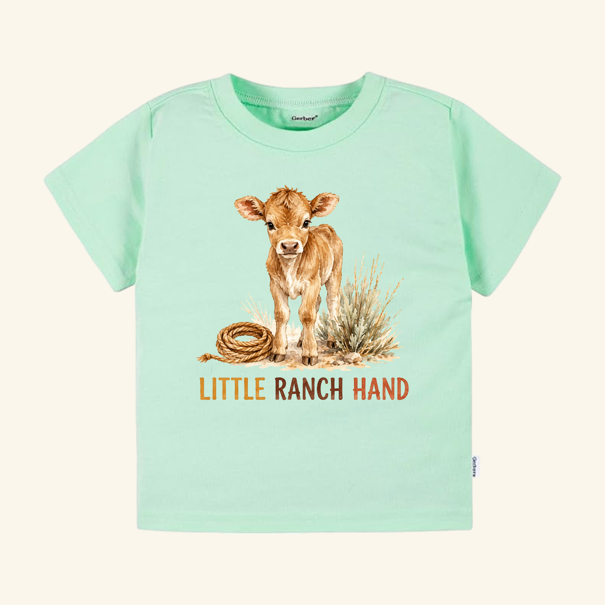 Light green Little Ranch Hand Toddler Shirt – Western Baby Calf Country Tee featuring a watercolor illustration of a calf standing next to a coiled rope and grass, with the text LITTLE RANCH HAND printed below.