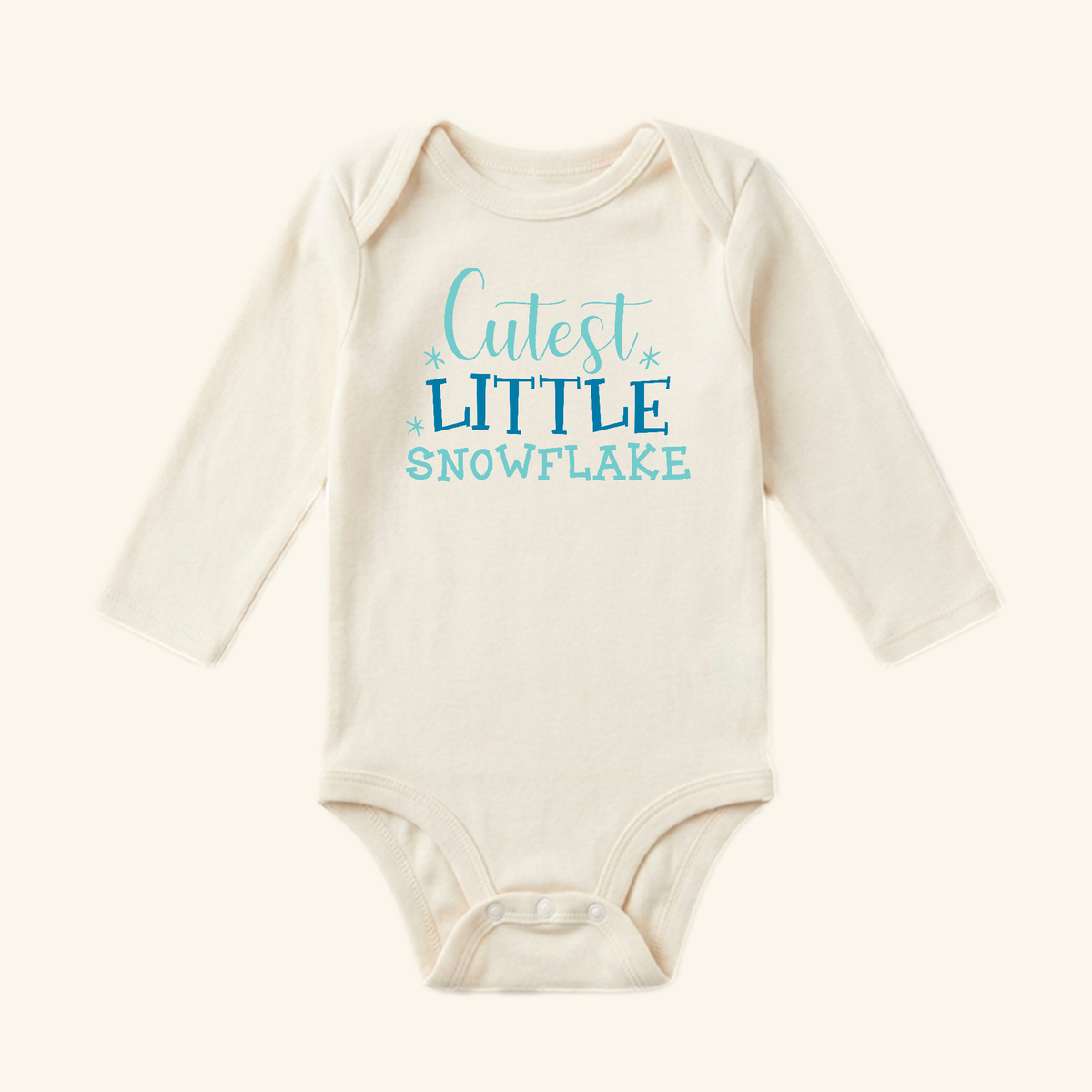 Cream long-sleeve Winter Baby Onesie – Cutest Little Snowflake Bodysuit by Toodleroos with Cutest Little Snowflake printed in blue text.