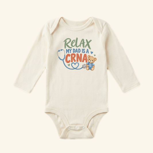 Toodleroos Relax My Dad Is a CRNA Baby Onesie featuring a teddy bear in scrubs with a stethoscope and the text Relax My Dad Is a CRNA.