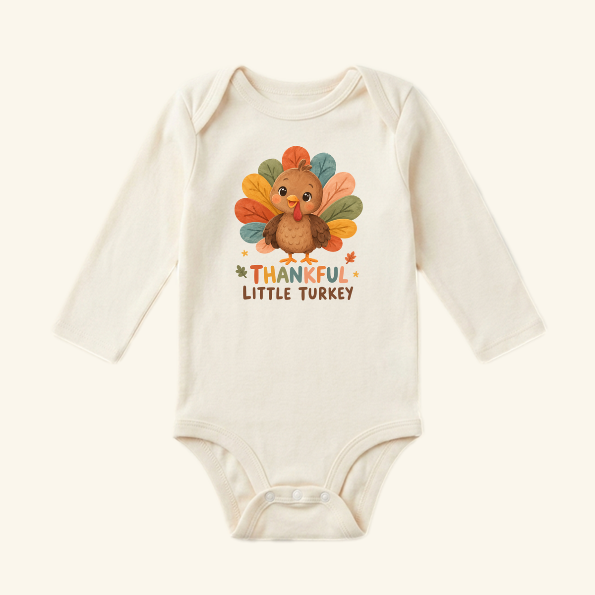 Cream long-sleeve Thankful Little Turkey Baby Onesie – Thanksgiving Bodysuit featuring a cartoon turkey graphic and the text THANKFUL LITTLE TURKEY, perfect as a fall baby outfit.