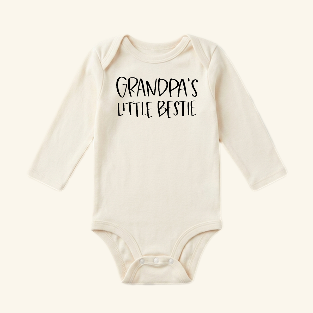Cream-colored long-sleeve Grandpa Baby Onesie – Grandpa’s Little Bestie Bodysuit with the text printed on the chest.