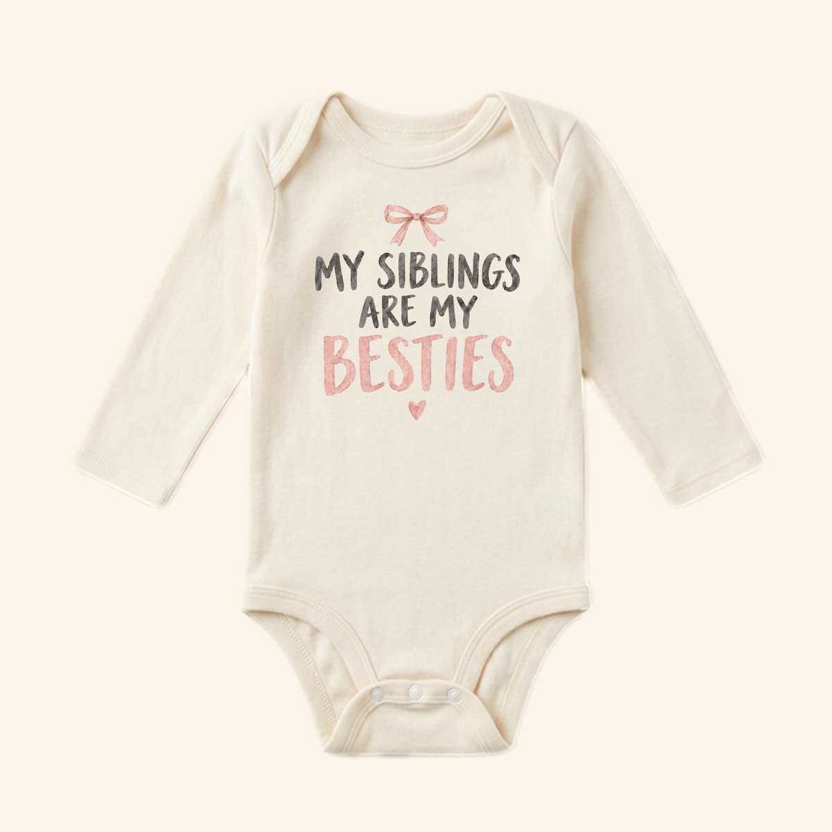 My Siblings Are My Besties Baby Onesie – Pink Bow Sibling Bodysuit featuring a pink bow illustration and the text MY SIBLINGS ARE MY BESTIES printed in gray and pink on a long-sleeved baby bodysuit.