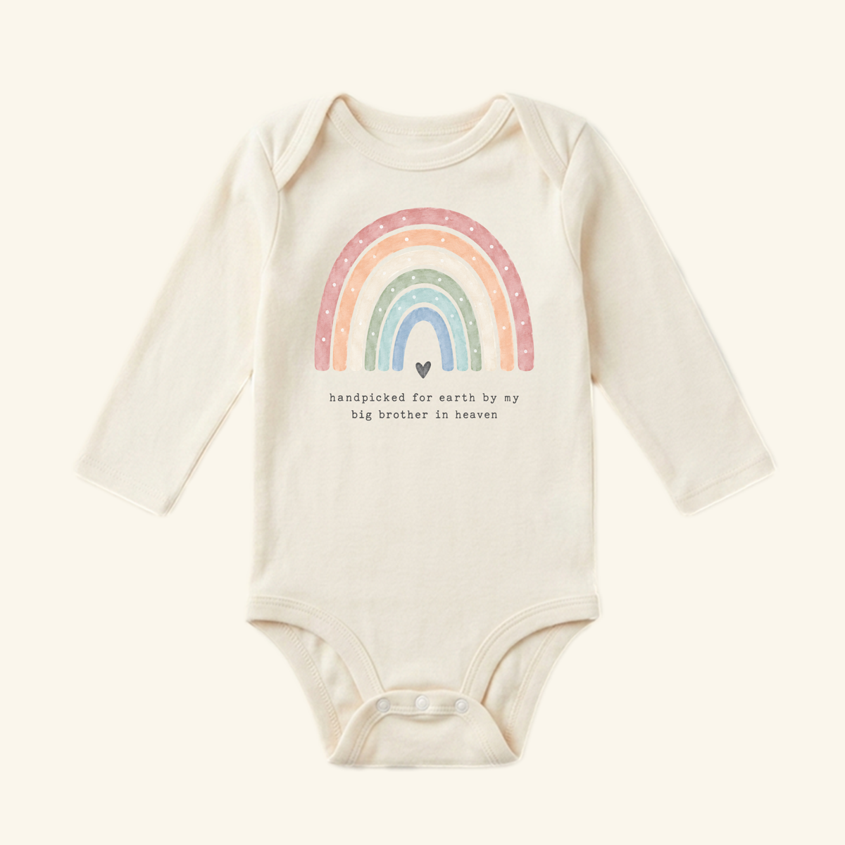 Toodleroos Rainbow Baby Onesie – Handpicked by My Big Brother in Heaven featuring a long-sleeve design, a watercolor graphic, a small heart, and the text, handpicked for earth by my big brother in heaven.