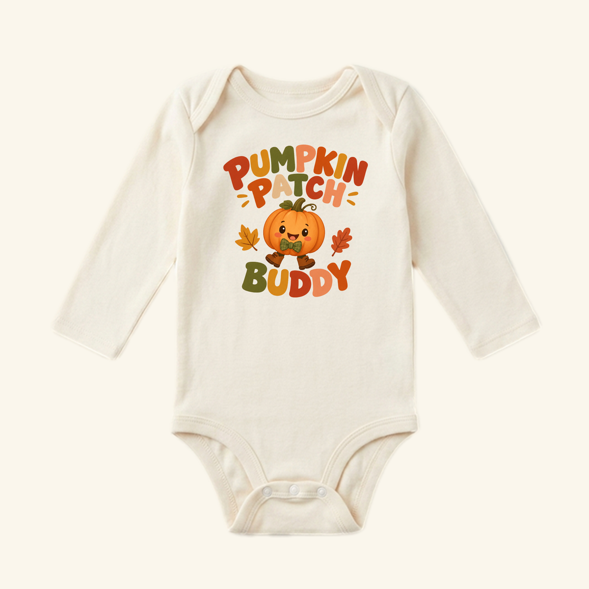 Toodleroos Pumpkin Patch Buddy Baby Onesie – Fall Pumpkin Bodysuit in cream, featuring a smiling pumpkin character in a bow tie surrounded by autumn leaves.