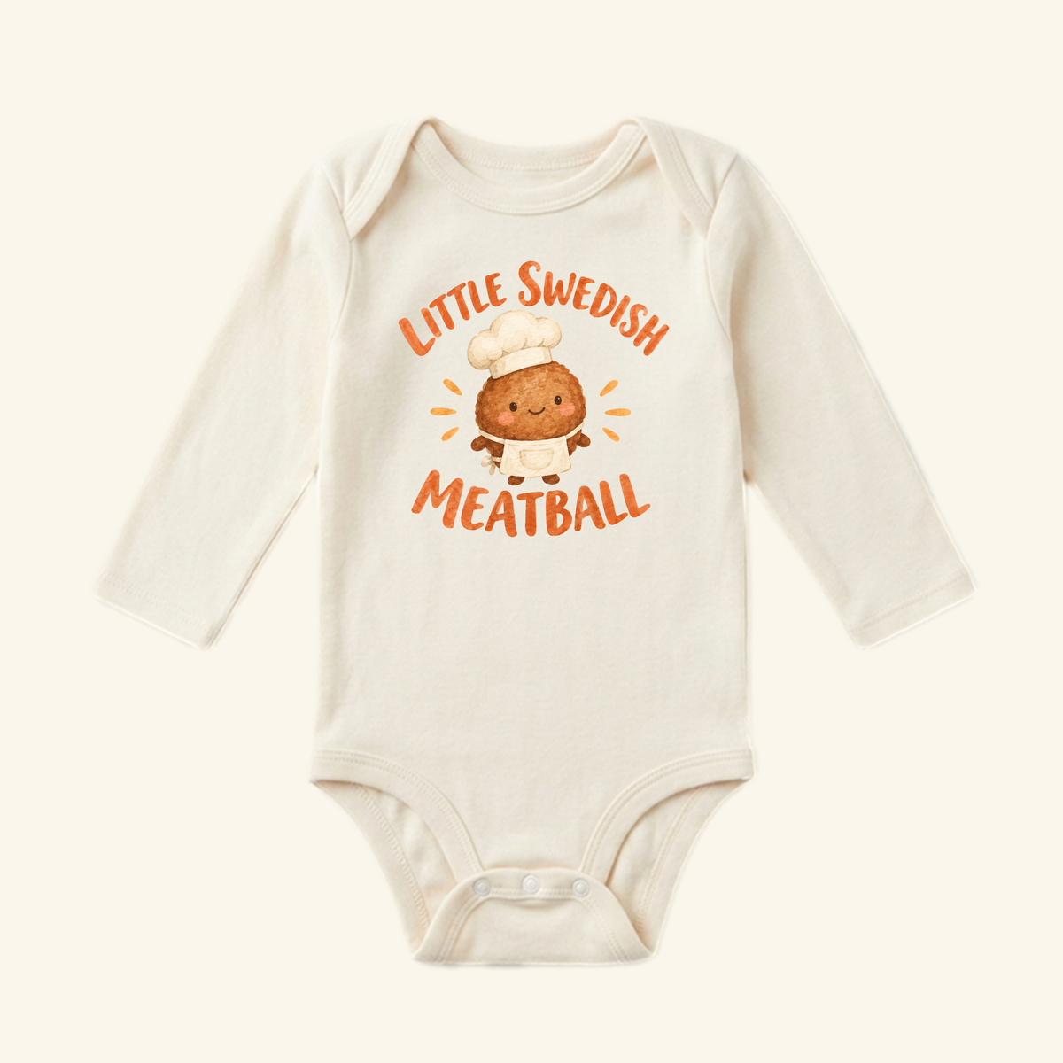 Little Swedish Meatball Baby Onesie – Cute Chef Bodysuit in cream, featuring a long-sleeve design with a cartoon meatball in a chef’s hat and apron and the text Little Swedish Meatball.