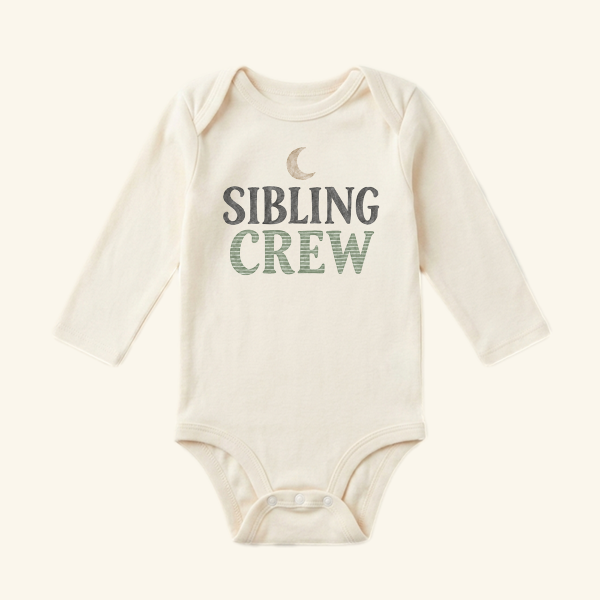 Cream-colored long-sleeve Sibling Crew Baby Onesie – Moon Matching Sibling Bodysuit featuring a crescent moon icon and SIBLING CREW printed on the chest.