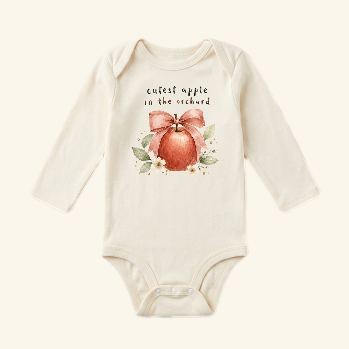Toodleroos Cutest Apple in the Orchard Baby Onesie – Fall Apple Bow Bodysuit featuring an illustration of an apple tied with a bow, surrounded by leaves and text that reads cutest apple in the orchard.