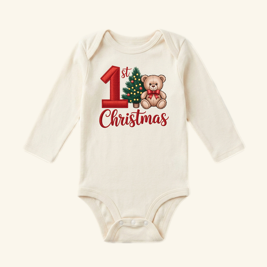 Toodleroos Baby’s First Christmas Onesie – Teddy Bear & Christmas Tree Bodysuit featuring a graphic of a decorated tree, a teddy bear with a red bow, and the text 1st Christmas.