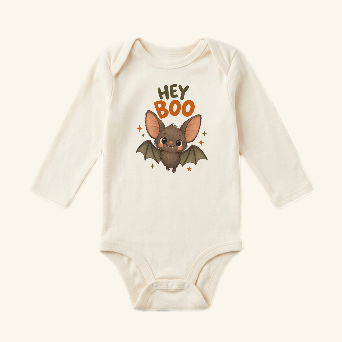 Toodleroos Hey Boo Bat Baby Halloween Onesie, a cream-colored long-sleeve bodysuit featuring a cartoon bat, the text HEY BOO, and a festive design perfect as a first Halloween outfit.