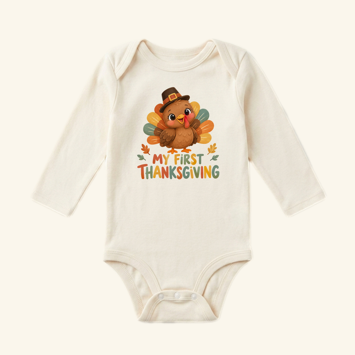 Toodleroos My First Thanksgiving Baby Onesie – Pilgrim Turkey Bodysuit, a long-sleeved cream baby bodysuit featuring a cartoon turkey in a pilgrim hat with the text My First Thanksgiving.