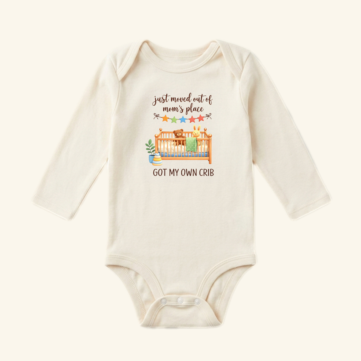Toodleroos Funny Baby Onesie – Got My Own Crib Bodysuit featuring an illustration of a teddy bear and rabbit in a crib with the text, Just moved out of mom’s place and GOT MY OWN CRIB.