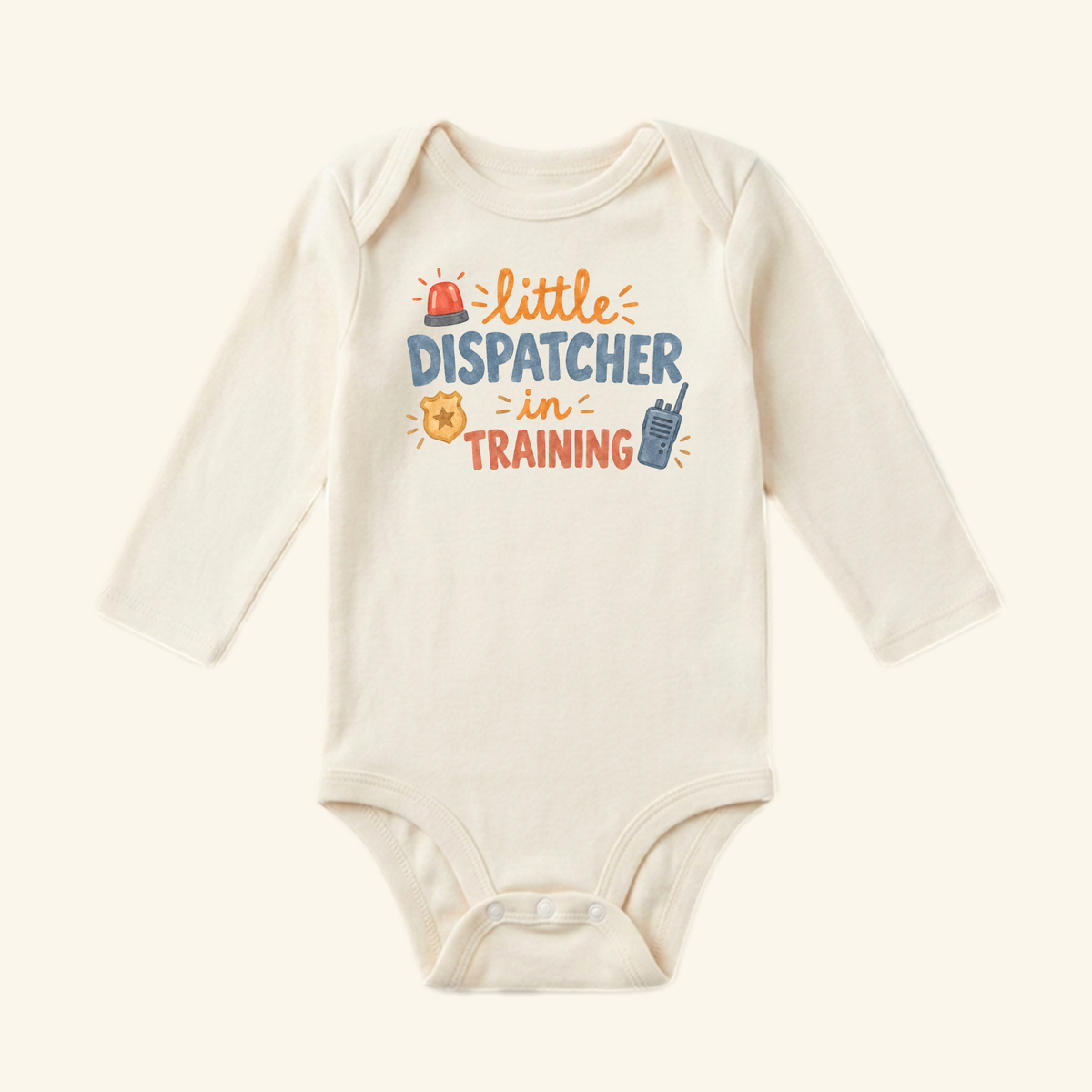 Long-sleeved cream Little Dispatcher in Training Baby Onesie featuring a graphic with a siren, badge, and walkie-talkie icons.