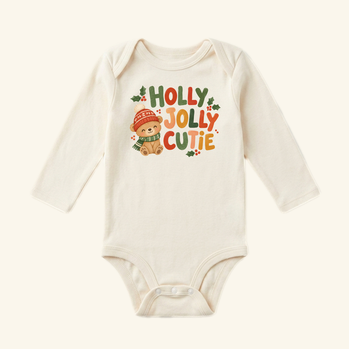 Holly Jolly Cutie Baby Onesie featuring a graphic of a teddy bear wearing a winter hat and scarf with the text Holly Jolly Cutie.