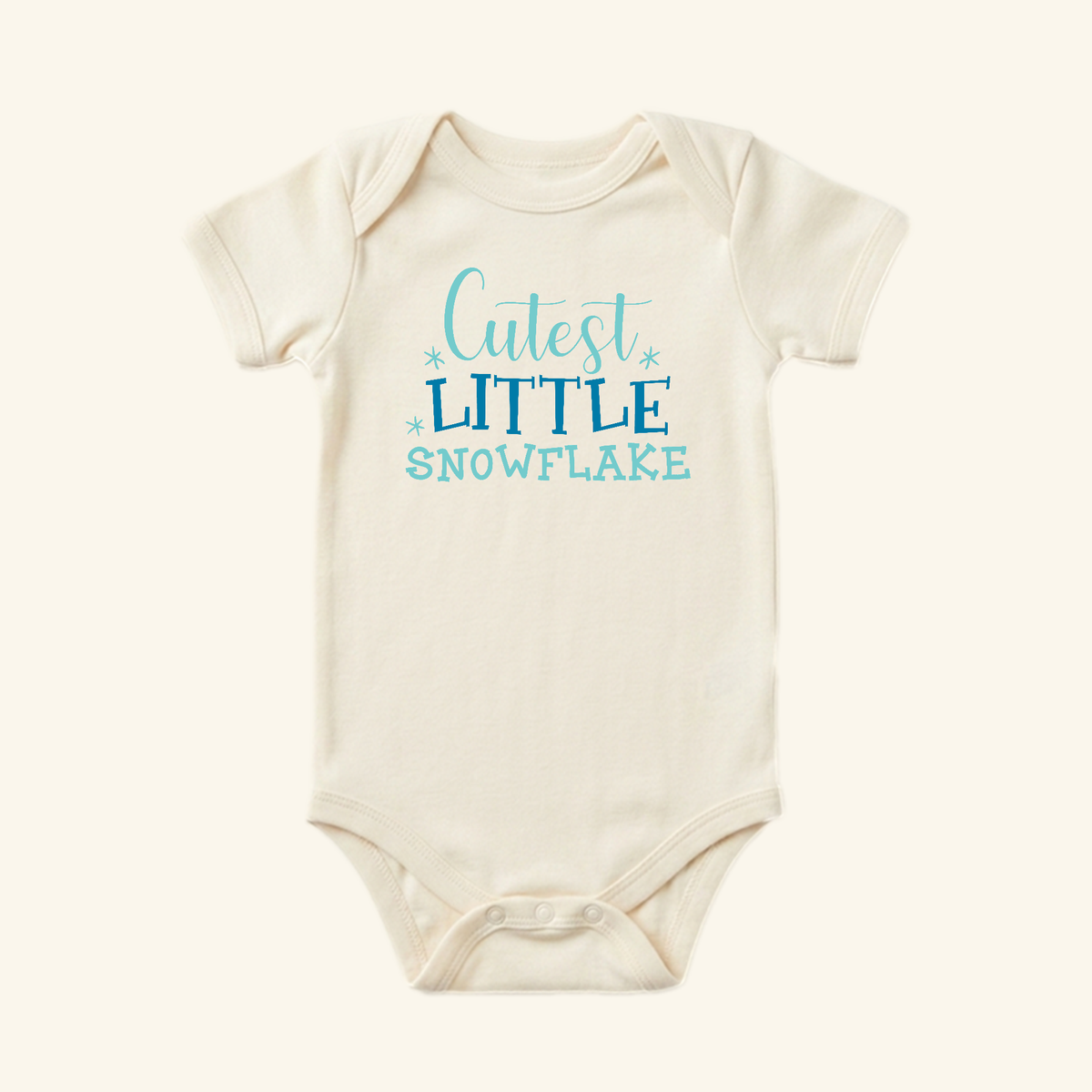 Toodleroos Winter Baby Onesie – Cutest Little Snowflake Bodysuit in off-white with short sleeves and blue chest text.