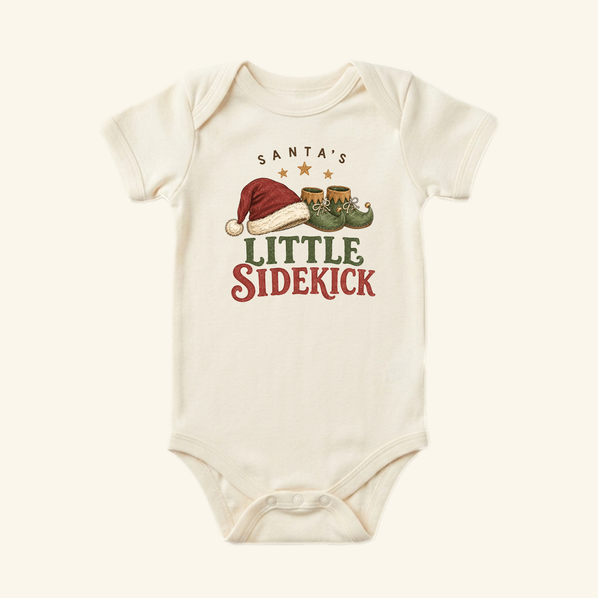 Cream-colored Santa’s Little Sidekick Baby Onesie – Christmas Elf Bodysuit featuring a graphic of a Santa hat and elf shoes with the text Santa’s Little Sidekick.