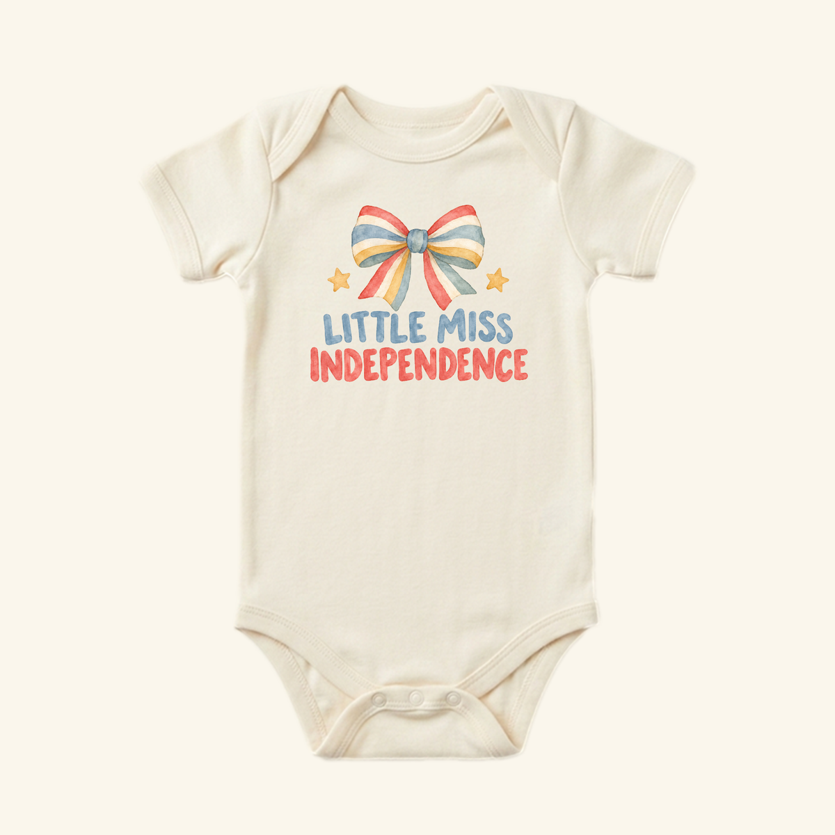 Little Miss Independence Baby Onesie – Patriotic Bow Bodysuit featuring a watercolor graphic of a red, white, and blue bow, two small stars, and the text LITTLE MISS INDEPENDENCE.