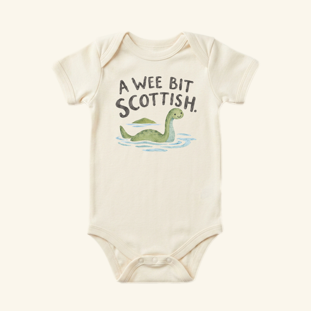 Off-white A Wee Bit Scottish Baby Onesie featuring an illustration of the Loch Ness monster in water and the text A Wee Bit Scottish.
