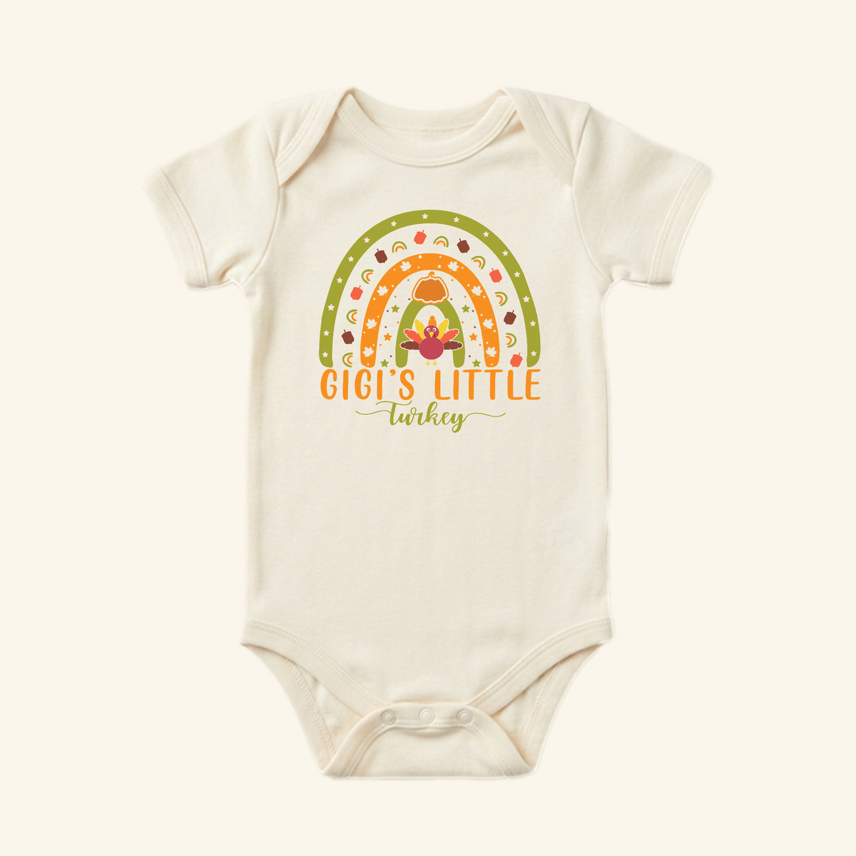 Cream-colored Gigi’s Little Turkey Baby Onesie – Grandma Thanksgiving Rainbow Bodysuit featuring a colorful rainbow graphic and a turkey for Baby’s First Thanksgiving.
