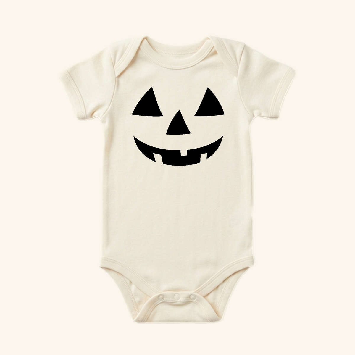 Off-white Toodleroos Halloween Baby Onesie – Jack-O’-Lantern Pumpkin Bodysuit featuring a black jack-o-lantern face.