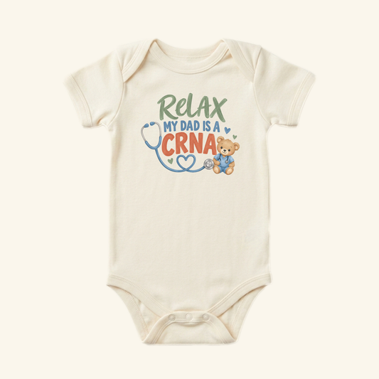 Off-white Relax My Dad Is a CRNA Baby Onesie – Funny Nurse Anesthetist Bodysuit featuring a graphic of a teddy bear wearing scrubs next to a stethoscope and the text Relax My Dad Is a CRNA.