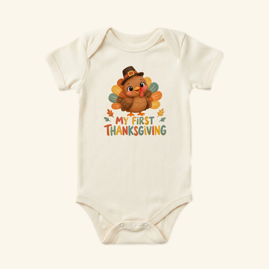 Cream-colored My First Thanksgiving Baby Onesie – Pilgrim Turkey Bodysuit featuring a cartoon turkey wearing a pilgrim hat.