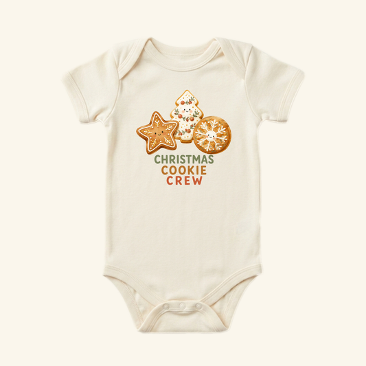 Cream-colored Toodleroos Christmas Cookie Crew Baby Onesie featuring illustrations of three decorated Christmas cookies and the text Christmas Cookie Crew.