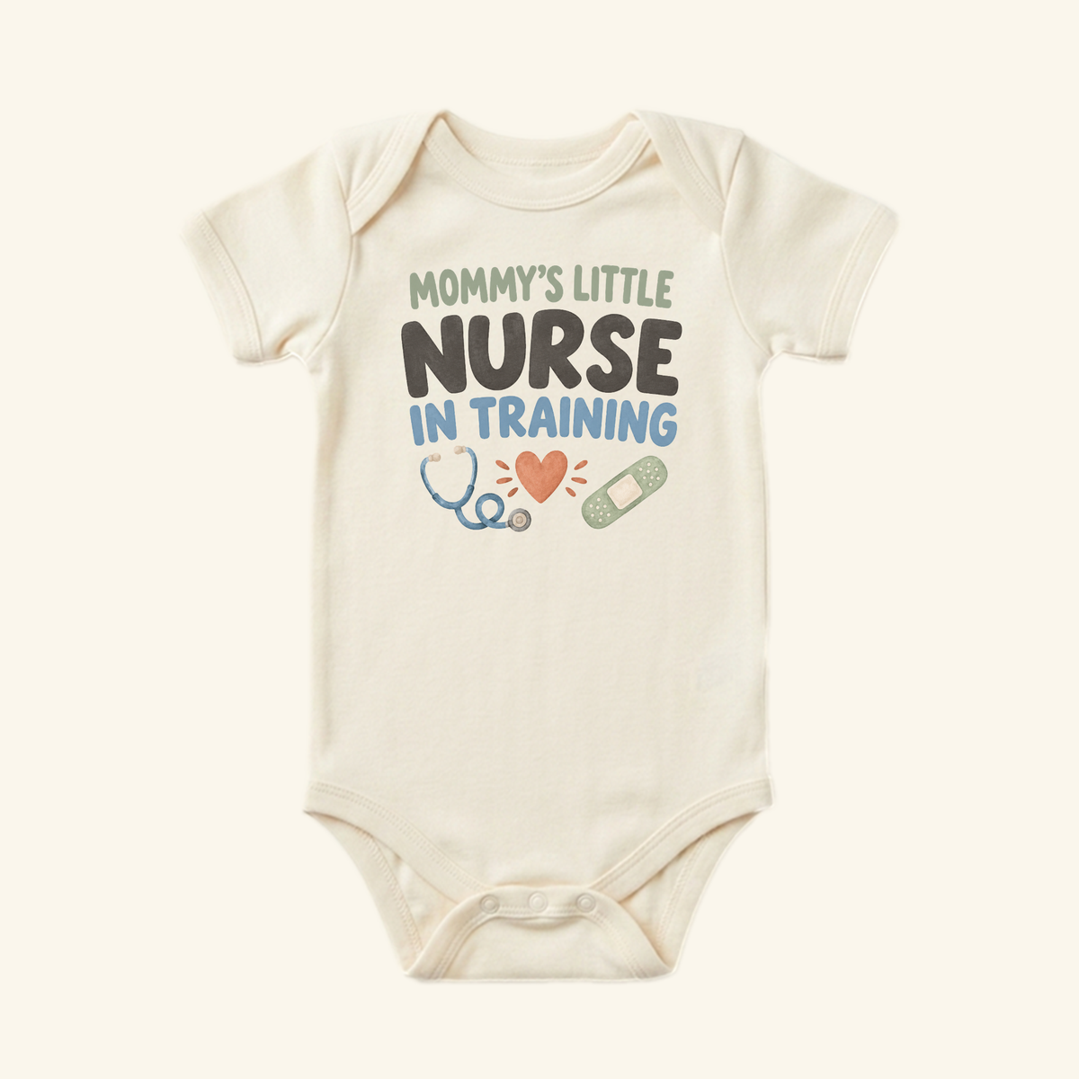 Cream-colored Mommy’s Little Nurse in Training Baby Onesie featuring the text Mommy’s little nurse in training with icons of a heart, a stethoscope, and a bandage.