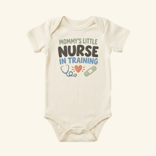 Cream-colored Mommy’s Little Nurse in Training Baby Onesie featuring the text Mommy’s little nurse in training with icons of a heart, a stethoscope, and a bandage.