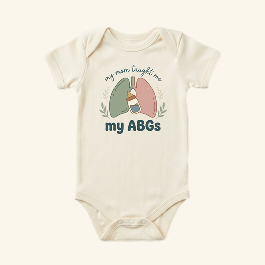 Toodleroos My Mom Taught Me My ABGs Baby Onesie featuring an illustration of lungs, a baby bottle, and the text my mom taught me my ABGs.