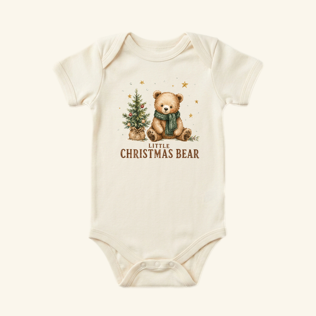 Cream-colored Little Christmas Bear Baby Onesie – Cute Teddy Bear Christmas Bodysuit featuring a teddy bear wearing a green scarf next to a small Christmas tree, with the text Little Christmas Bear below.