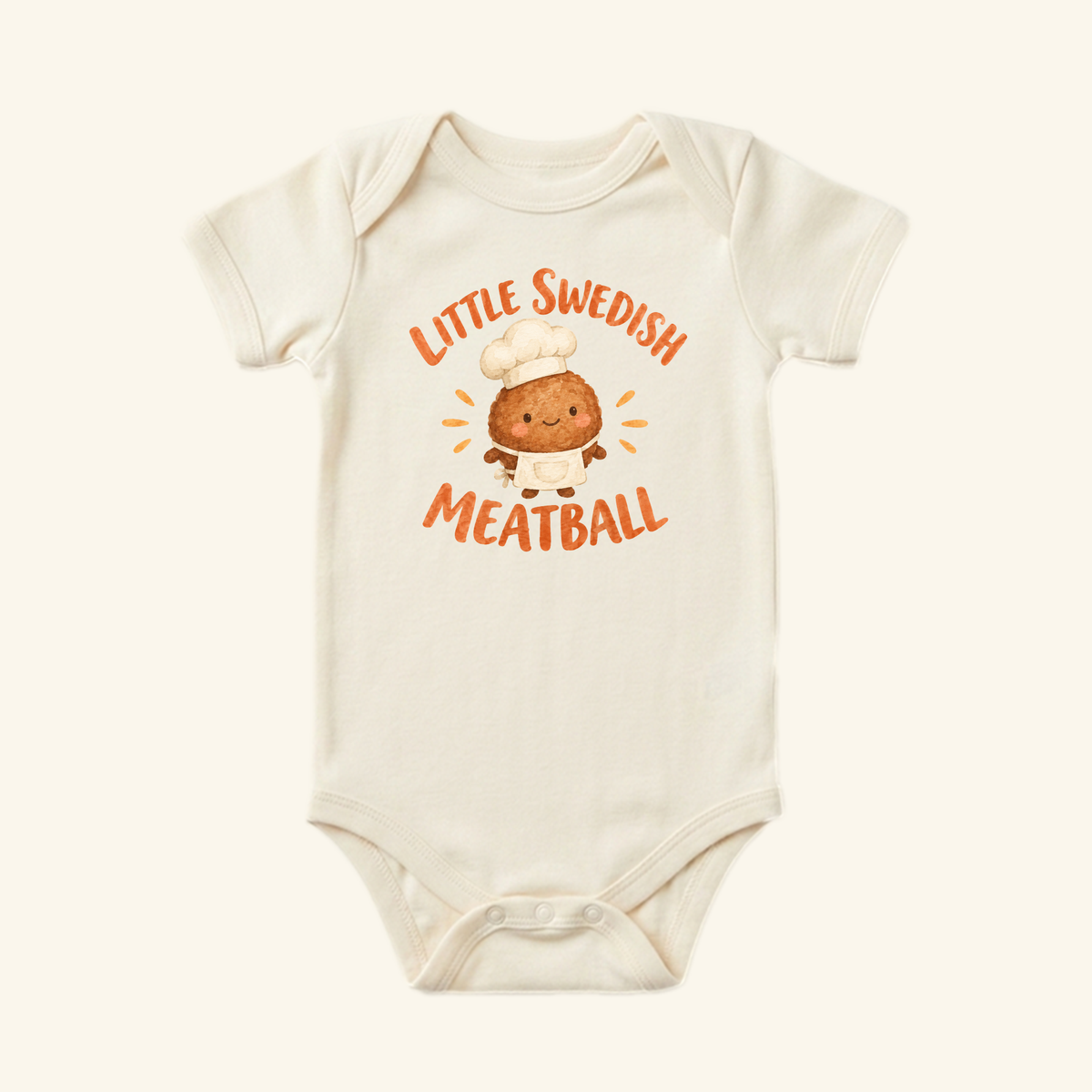 Cream-colored Little Swedish Meatball Baby Onesie – Cute Chef Bodysuit featuring a cartoon meatball in a chef’s hat and apron with the text Little Swedish Meatball.