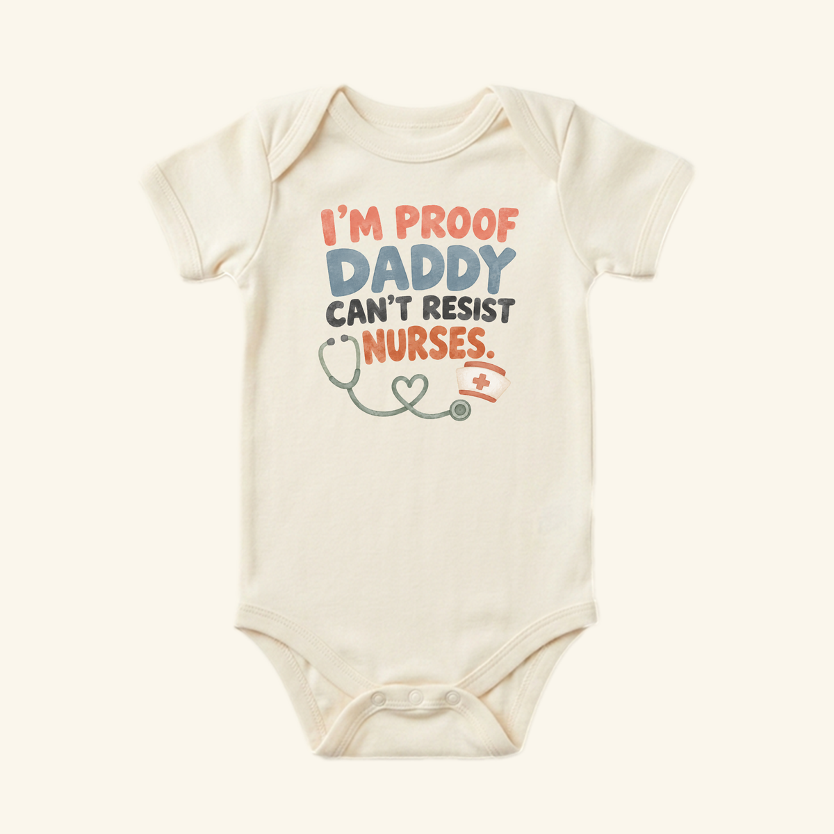 Cream-colored I’m Proof Daddy Can’t Resist Nurses Baby Onesie – Funny Nurse Mom Bodysuit printed with the text I’m proof daddy can’t resist nurses, accompanied by a stethoscope and nurse’s cap illustration.