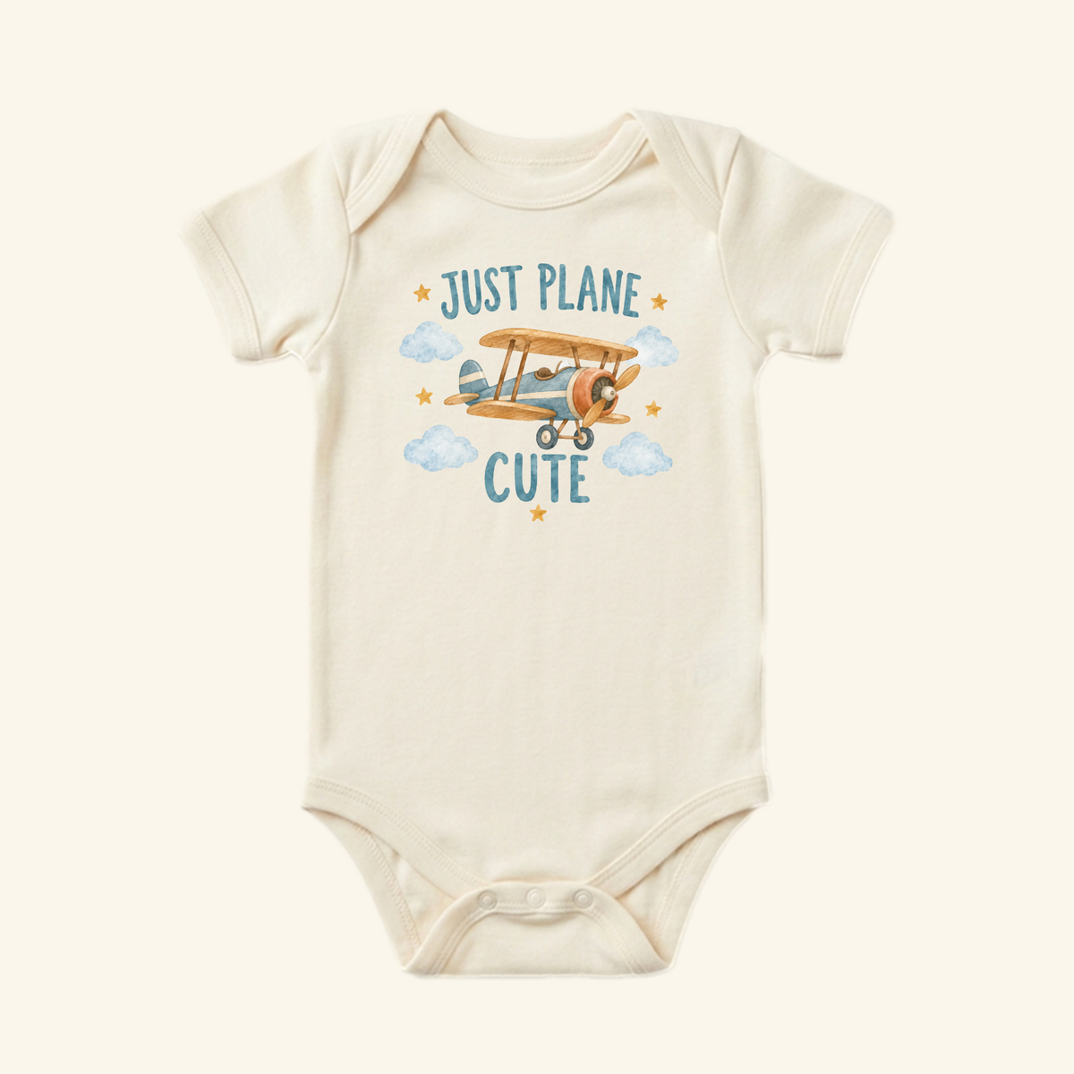 Cream-colored Just Plane Cute Baby Onesie – Funny Vintage Airplane Pun Bodysuit featuring a watercolor illustration of a vintage airplane surrounded by blue clouds and gold stars.