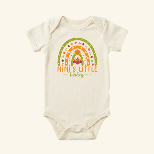 Cream-colored Mimi’s Little Turkey Baby Onesie – Grandma Thanksgiving Rainbow Bodysuit featuring a rainbow, a turkey, and the text Mimi’s Little Turkey.
