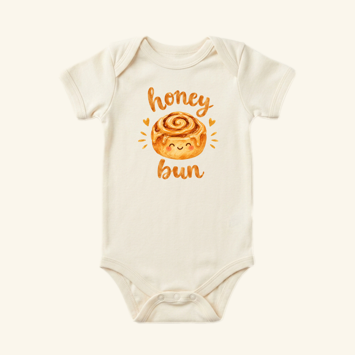 Toodleroos Cute Baby Onesie – Honey Bun Cinnamon Roll Bodysuit: cream-colored with a cinnamon roll and honey bun in playful orange script, perfect for any adorable baby outfit.