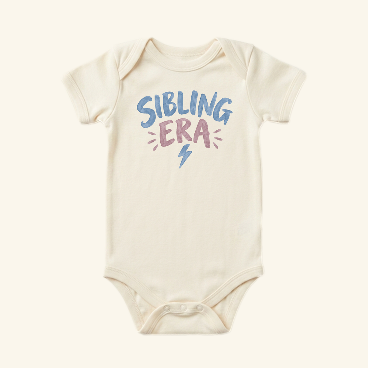 Toodleroos Sibling Era Baby Onesie in cream, featuring the text SIBLING ERA in blue and pink with a small blue lightning bolt below.