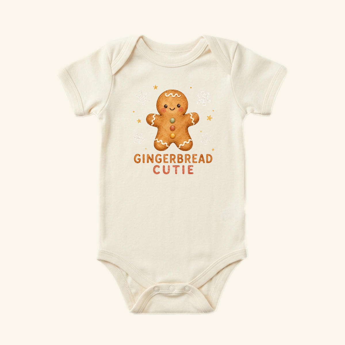 Cream-colored Gingerbread Cutie Baby Onesie featuring a gingerbread man graphic and the text GINGERBREAD CUTIE.