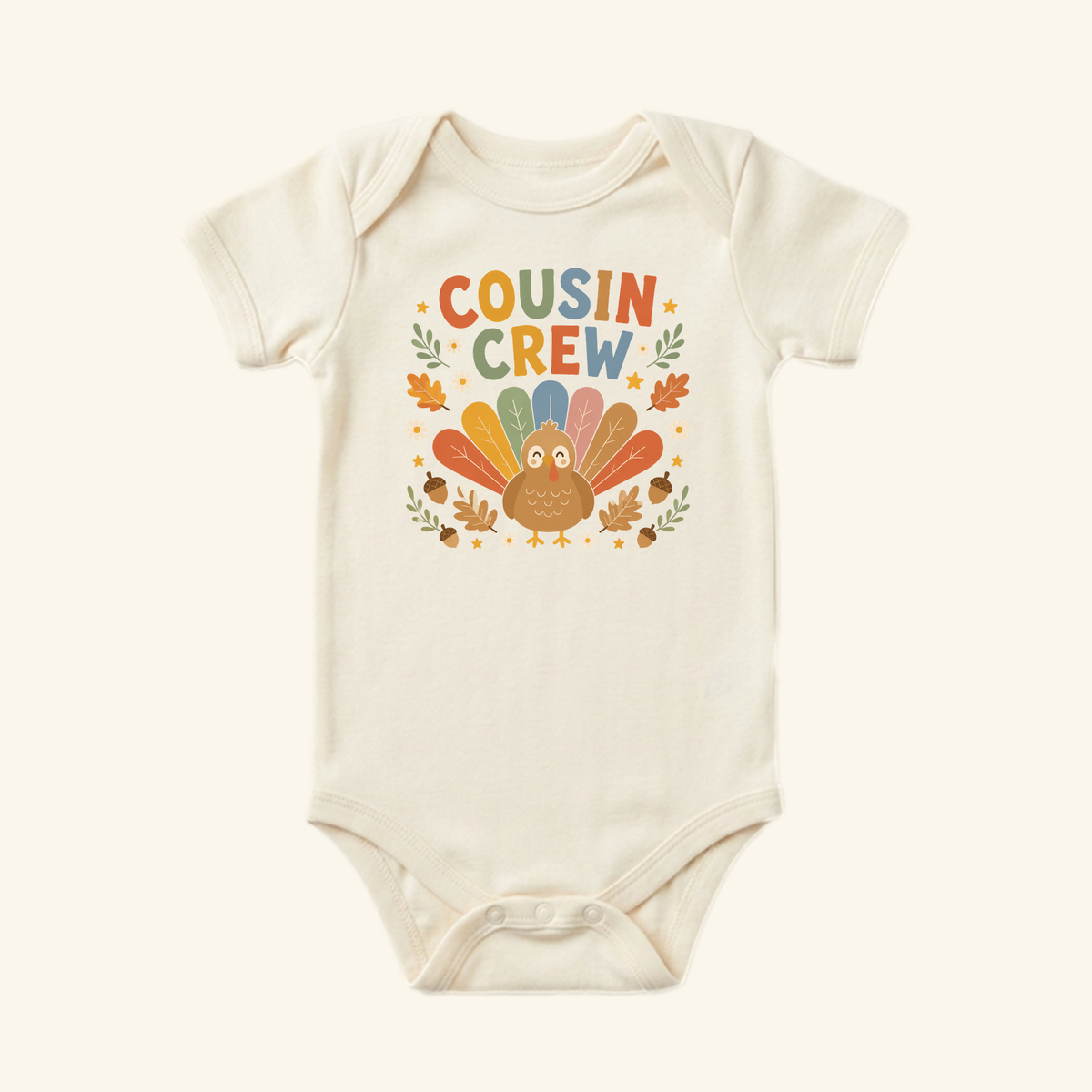 Toodleroos Thanksgiving Baby Onesie – Cousin Crew Turkey Bodysuit with a turkey graphic and COUSIN CREW text surrounded by autumn leaves and acorns.