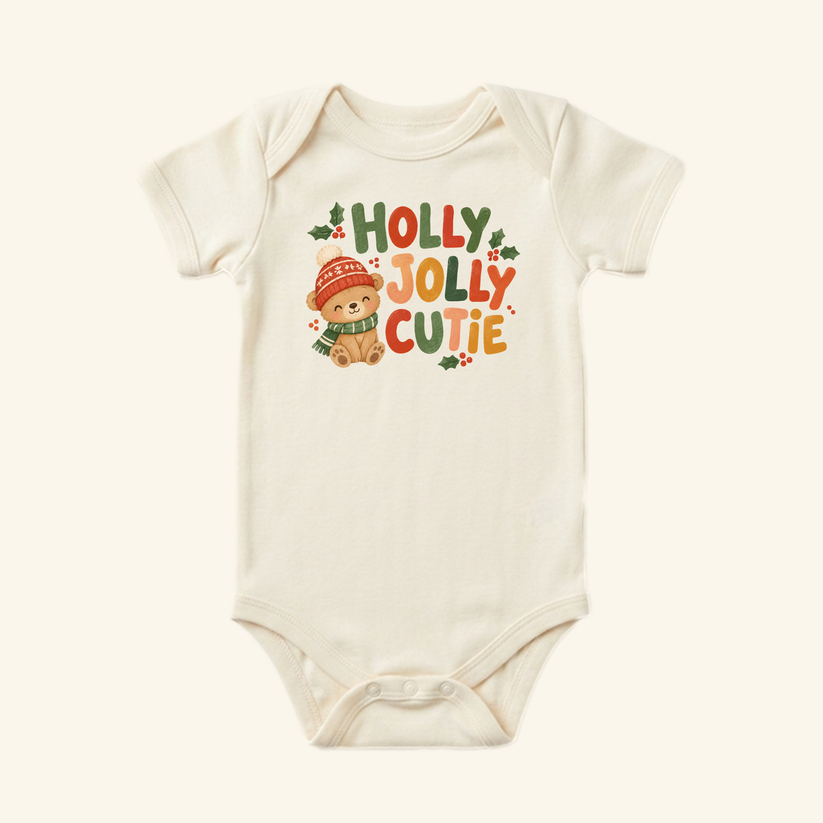 Off-white Holly Jolly Cutie Baby Onesie – Cute Teddy Bear Christmas Bodysuit featuring a cartoon teddy bear wearing a red hat and green scarf, surrounded by festive holly leaves.