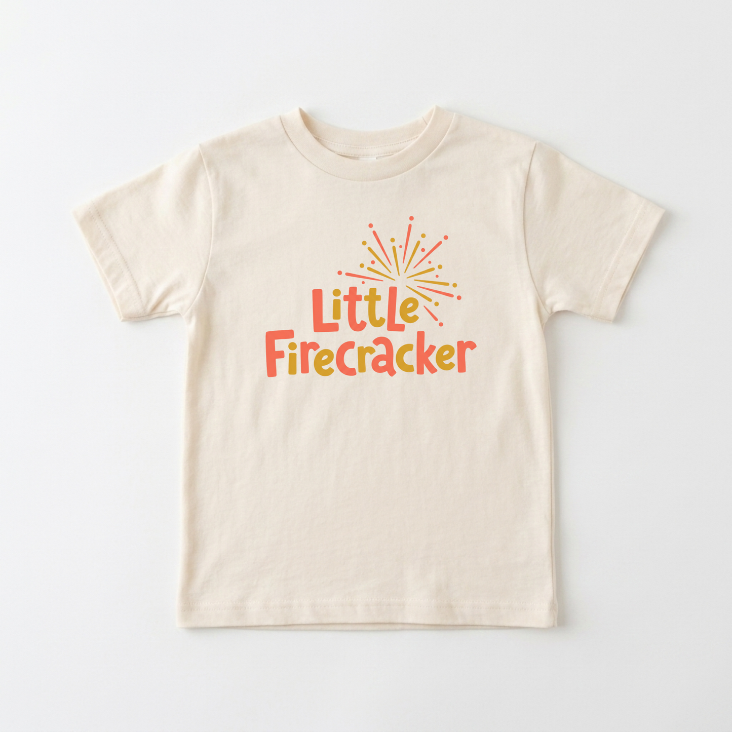 A cream-colored short-sleeve t-shirt with a colorful graphic on the chest that reads 'Little Firecracker' in orange and yellow text under a small firework illustration, displayed flat against a light gray background.