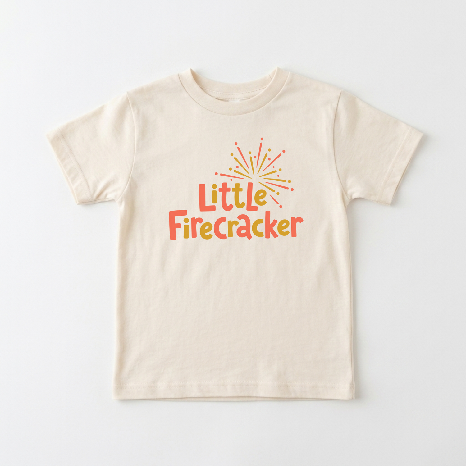 A cream-colored short-sleeve t-shirt with a colorful graphic on the chest that reads 'Little Firecracker' in orange and yellow text under a small firework illustration, displayed flat against a light gray background.