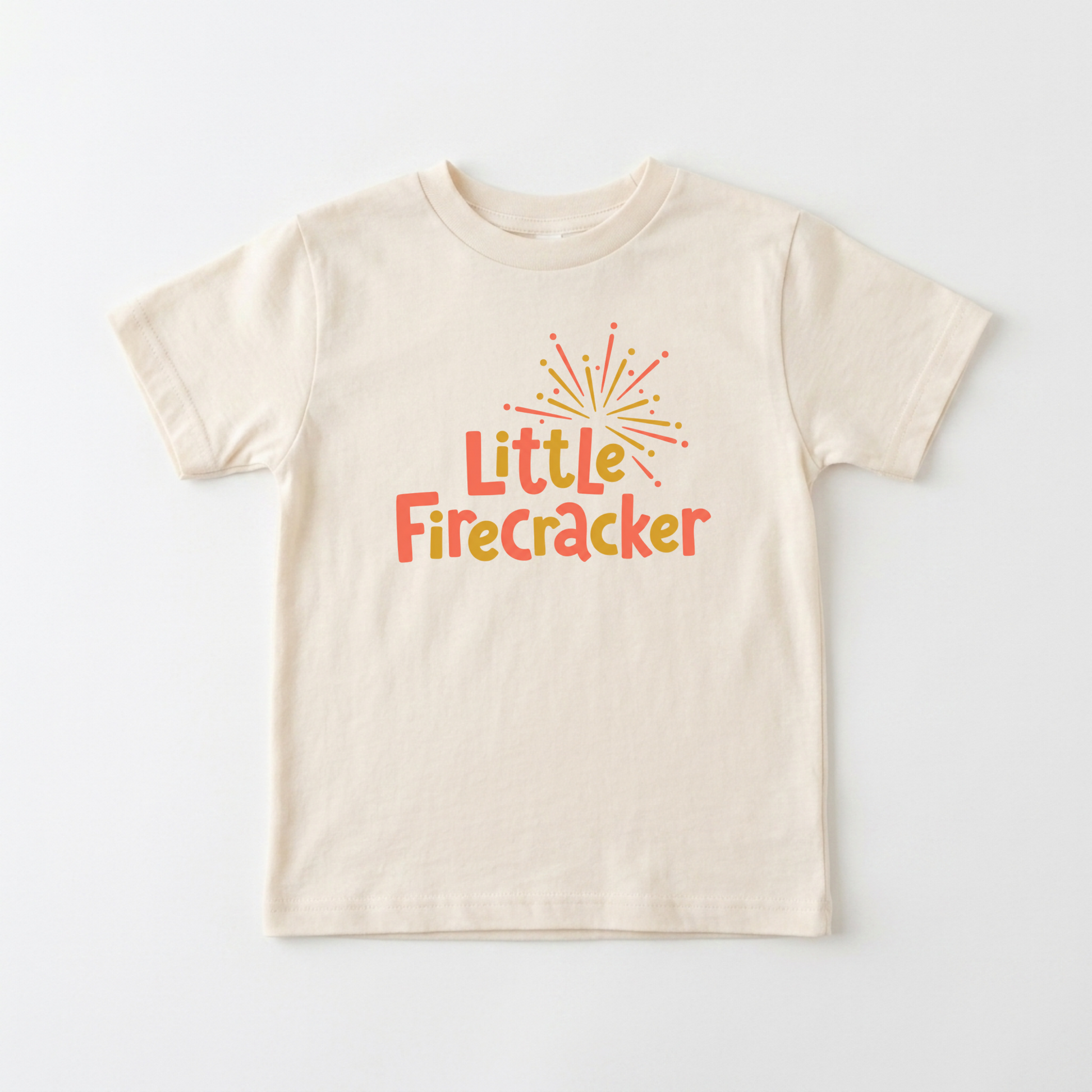 A cream-colored short-sleeve t-shirt with a colorful graphic on the chest that reads 'Little Firecracker' in orange and yellow text under a small firework illustration, displayed flat against a light gray background.
