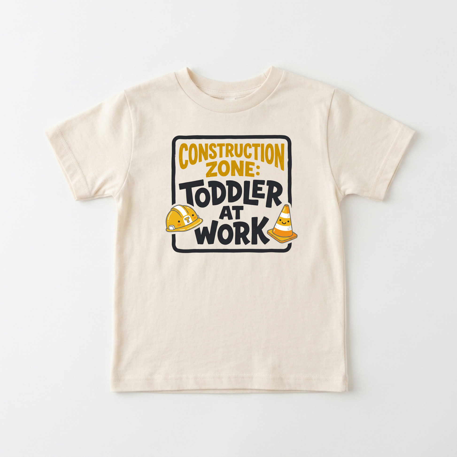 A cream-colored toddler short-sleeve t-shirt with a 'Construction Zone: Toddler at Work' graphic on the chest, displayed flat against a light gray background.