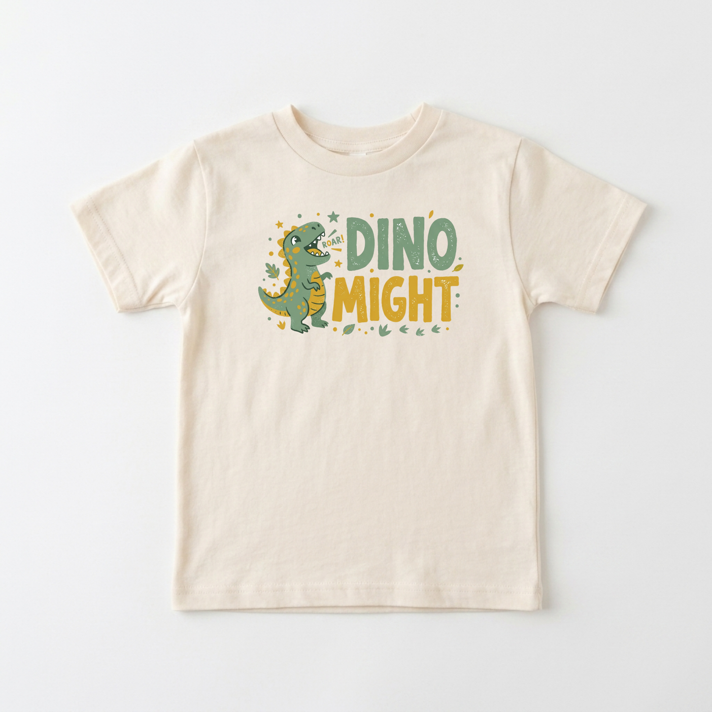 A cream-colored short-sleeve kids' t-shirt featuring a cartoon green dinosaur and the text 'DINO MIGHT' in green and yellow on the front, displayed against a clean white background.