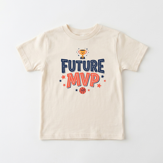A cream-colored short-sleeve t-shirt with a 'FUTURE MVP' graphic on the chest, featuring a gold trophy, blue and orange lettering, and small stars and a basketball, displayed on a clean white background.