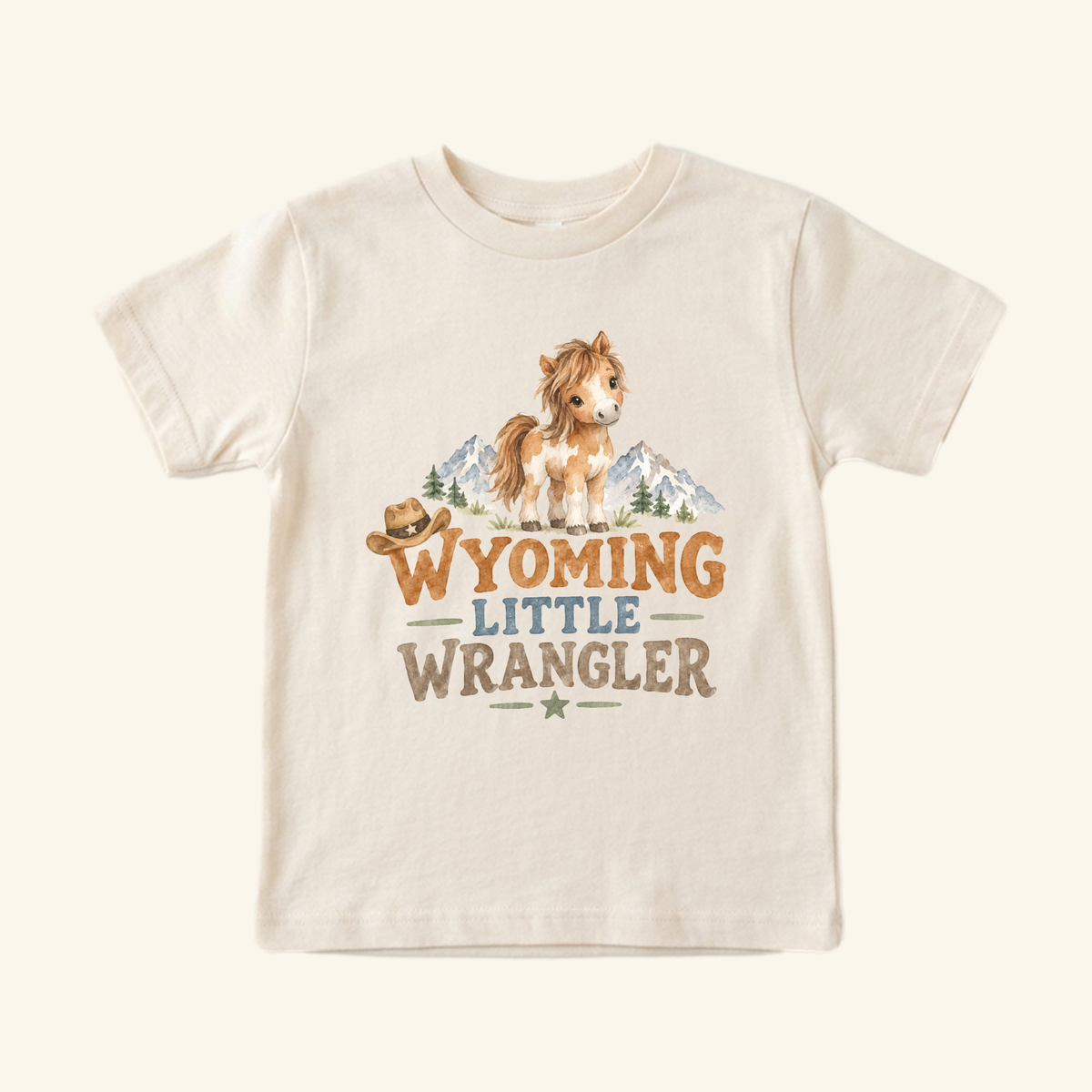 Wyoming Toddler Shirt – Little Wrangler Western Pony Tee featuring a watercolor graphic of a pony, a cowboy hat, and mountains with the text WYOMING LITTLE WRANGLER.